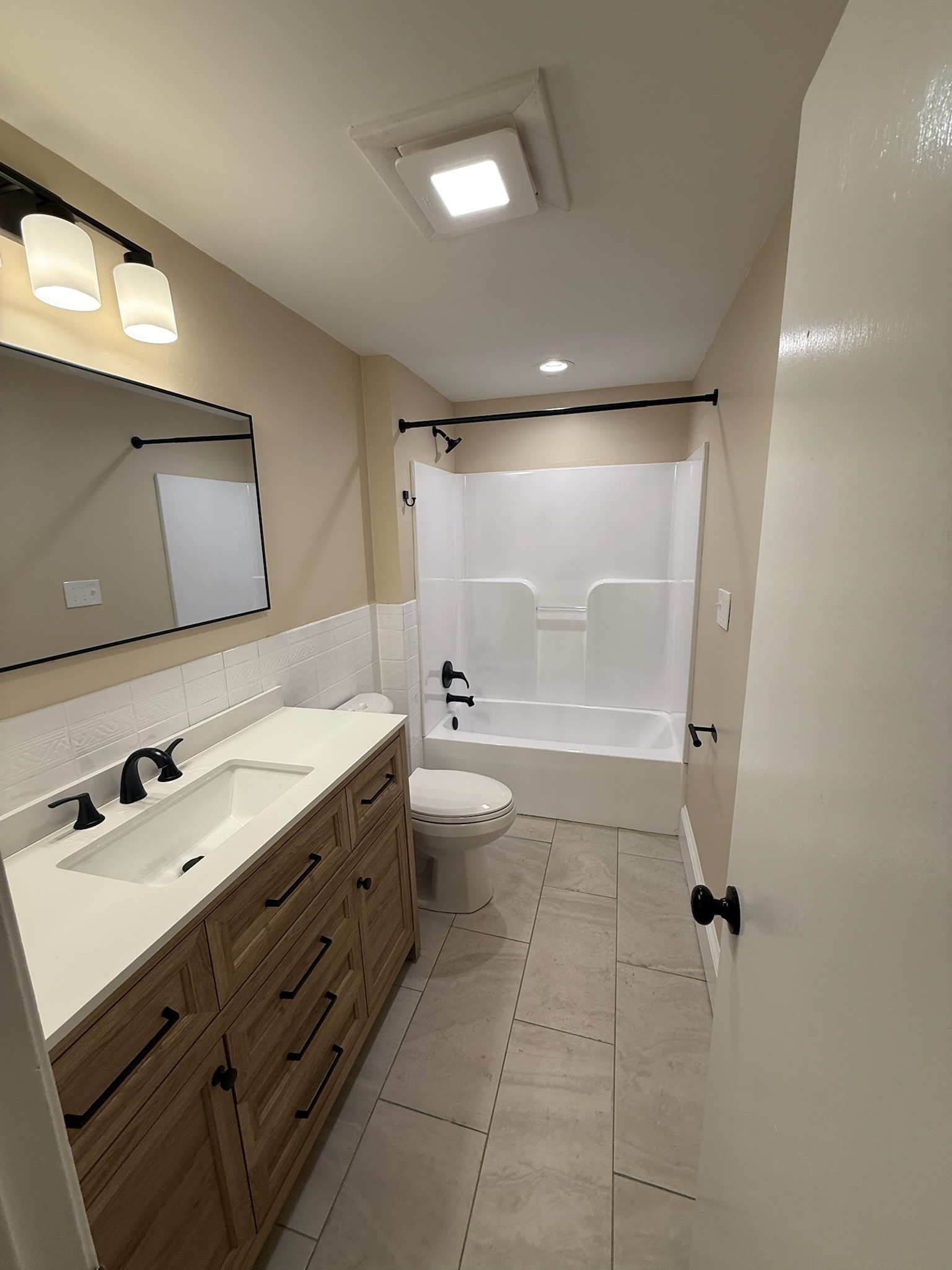 Stoneham bathroom — tub and shower with matte black fixtures