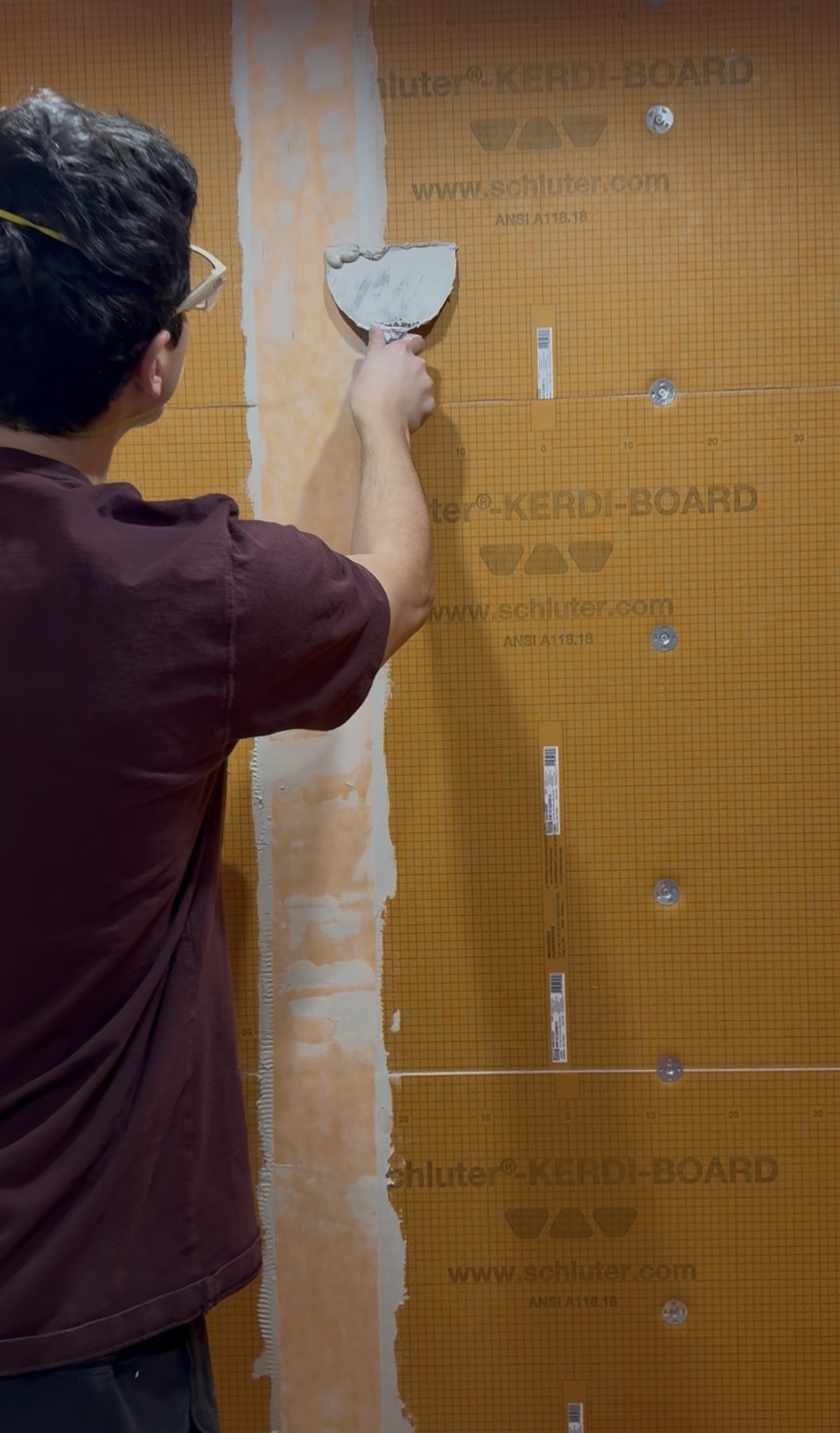 Applying waterproofing membrane to shower walls