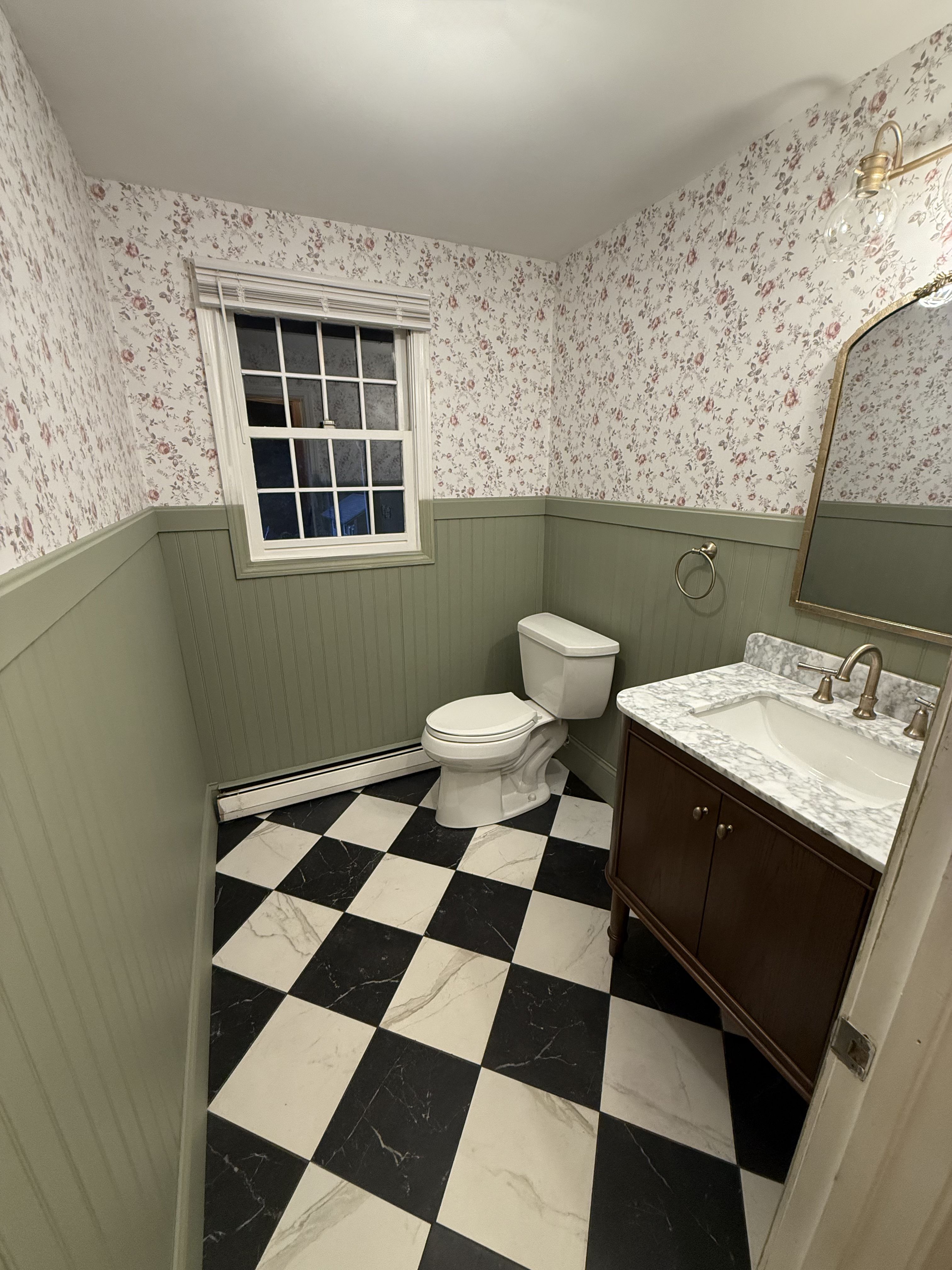 Andover bathroom — full room with floral wallpaper and checkered porcelain tile