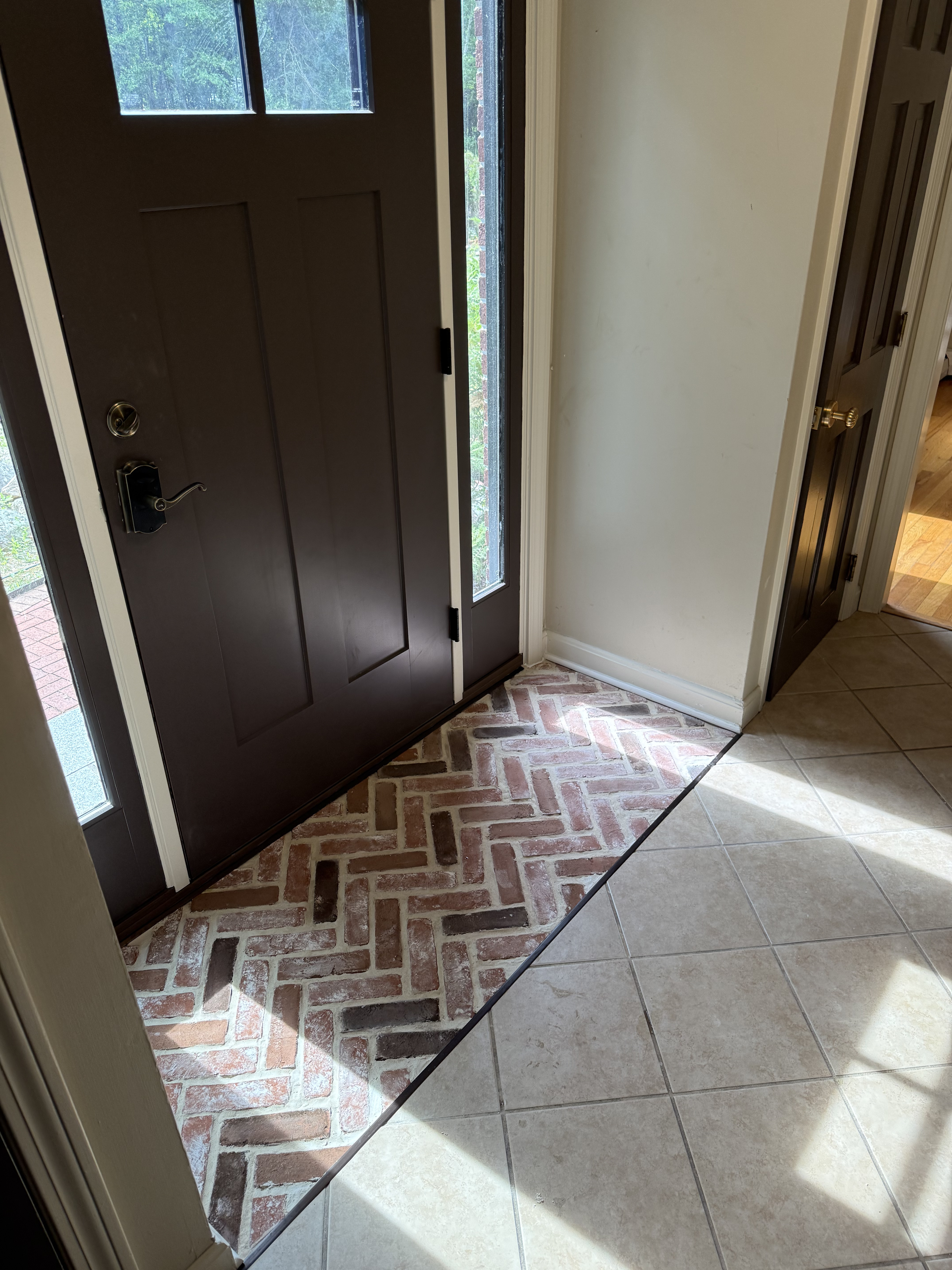 Herringbone brick tile entryway installation
