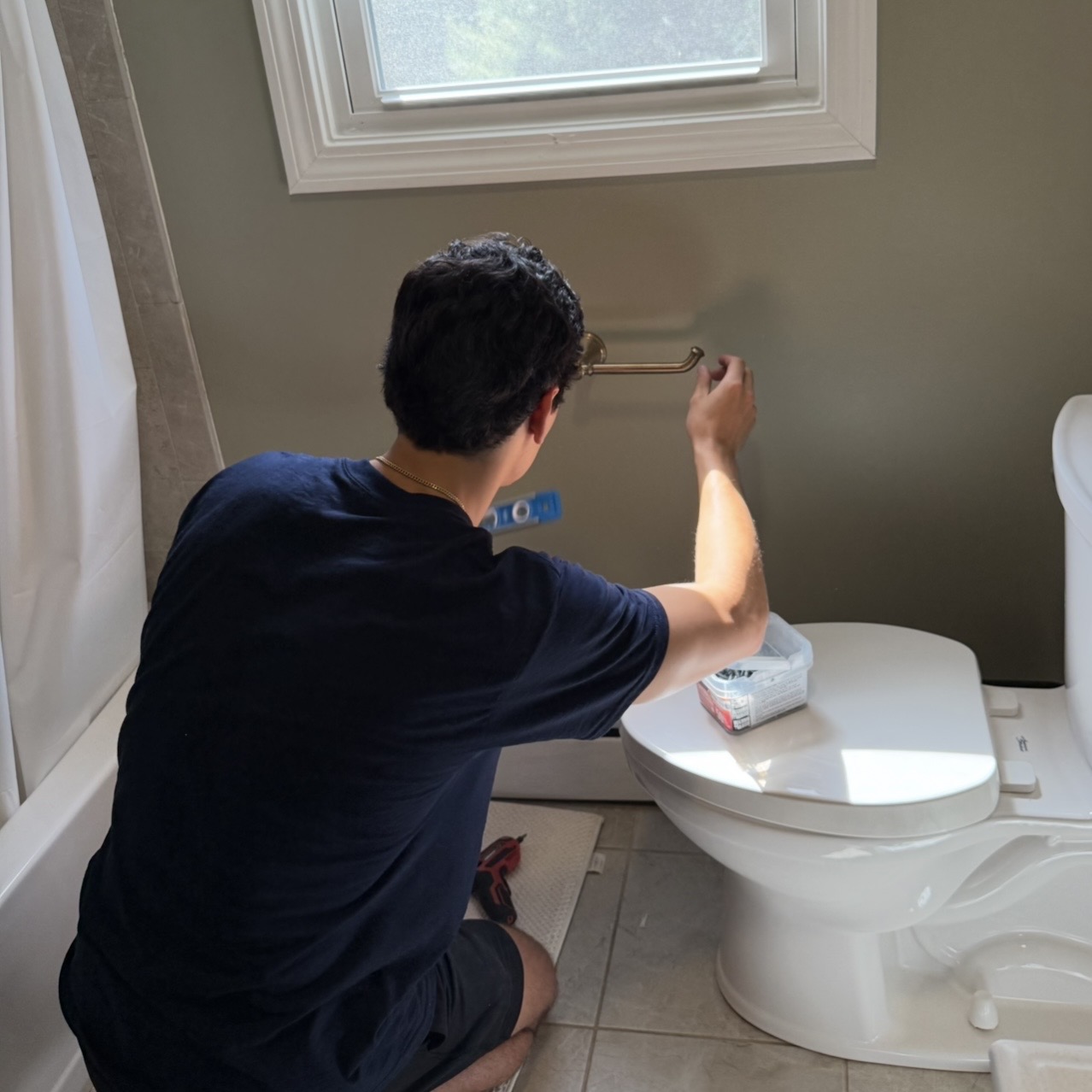 Installing brass towel bar in bathroom